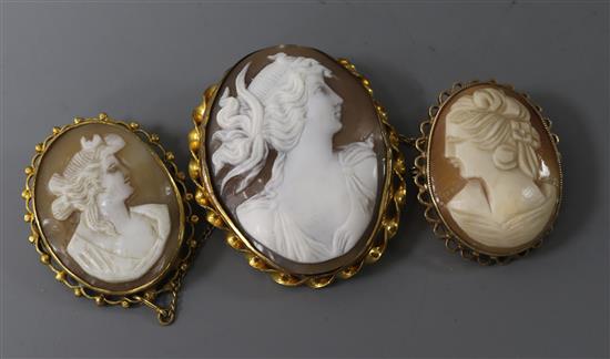 Three assorted mounted cameo brooches including 9ct gold, largest 44mm.